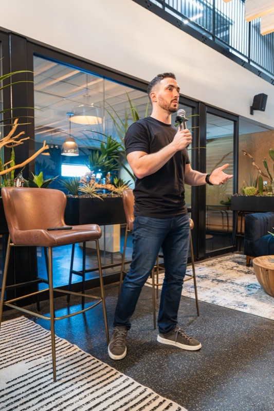 Connor Cullip on the mic in the Network of Directors room