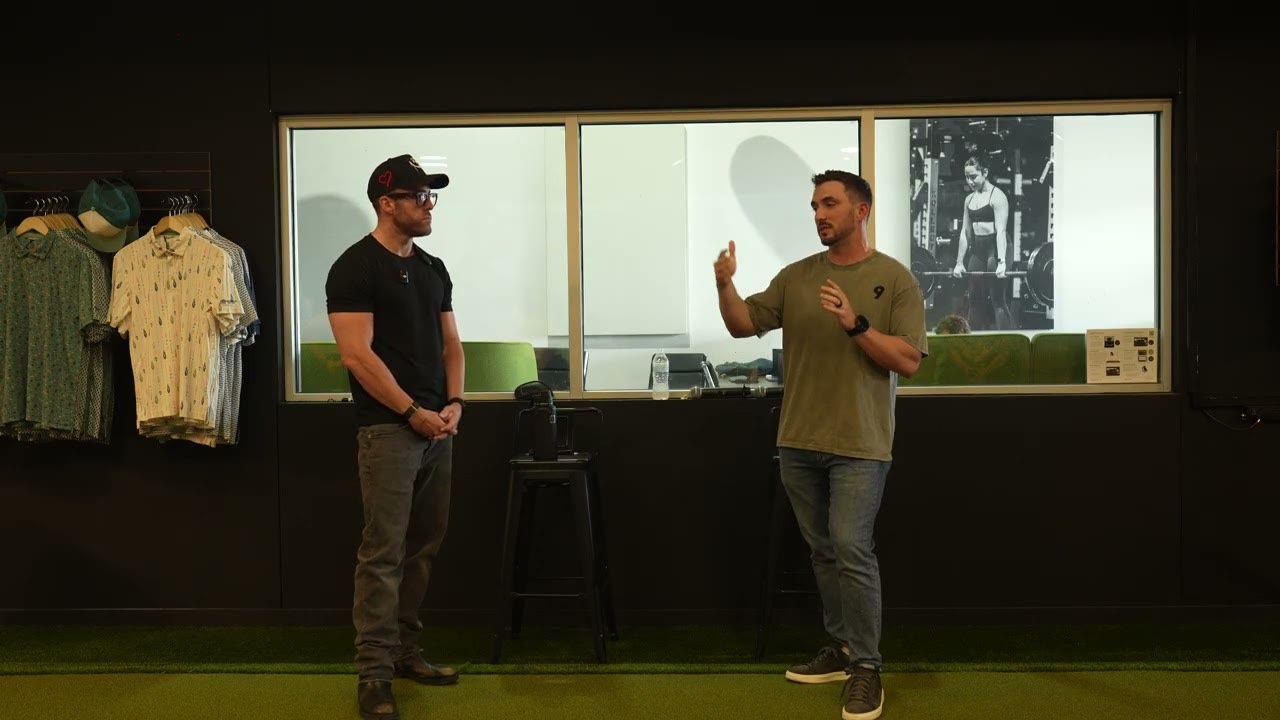 Justin Day and Connor Cullip talking on the turf at the Network of Directors room in Austin