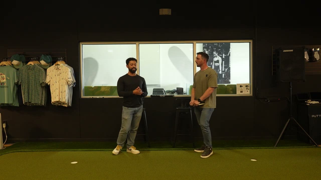 Griffin Wooden and Connor Cullip talking on the turf at the Network of Directors room in Austin